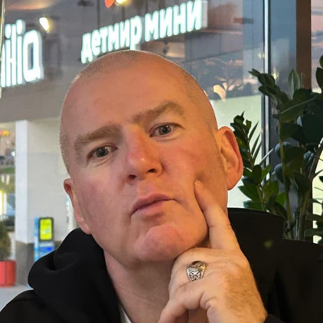 Hugh Mc Enaney — thoughtful portrait, hand to chin